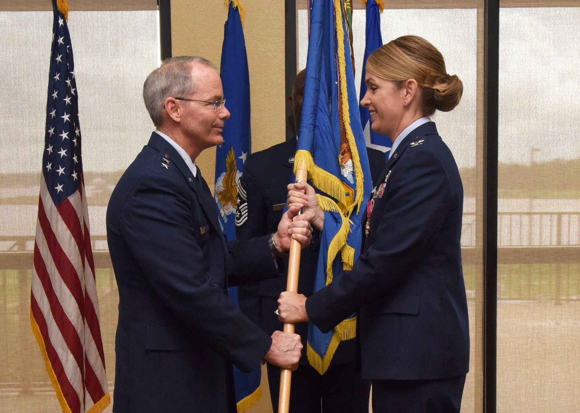 Maj. Gen. Bob LaBrutta, 2nd Air Force commander, takes the guidon from Col. Michele Edmondson, outgoing 81st Training Wing commander, during a change of command ceremony at the Bay Breeze Event Center June 2, 2017, on Keesler Air Force Base, Miss. The ceremony is a symbol of command being exchanged from one commander to the next. Edmondson is now assigned to be the executive officer to the vice chief of staff of the Air Force at the Pentagon in Washington D.C. (U.S. Air Force photo by Kemberly Groue) 