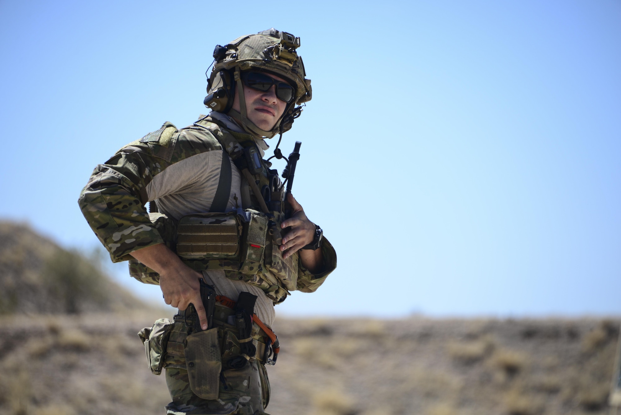 A U.S. Air Force pararescueman holsters his weapon during the Guardian Angel Mission Qualification Training course at Davis-Monthan Air Force Base, Ariz., May 17, 2017. The MQT is a 90 day GA Formal traning course that takes pararescuemen who have completed Air Education and Training Command schooling and helps them achieve their 5-level qualification. (U.S. Air Force photo by Airman 1st Class Nathan H. Barbour)