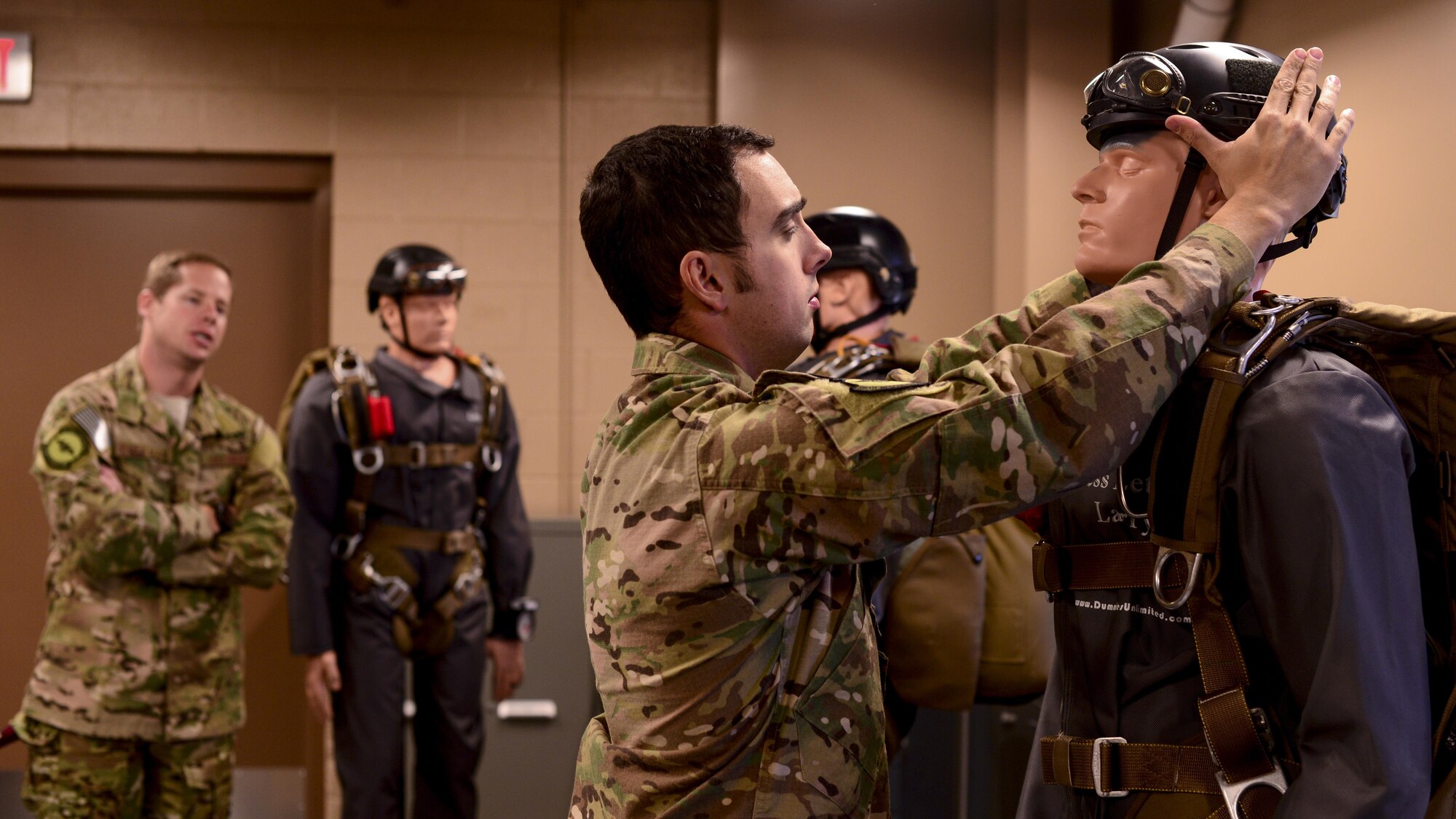 U.S. Air Force Tech. Sgt. Ken O’Brien, 68th Rescue Flight air operations instructor, and Staff Sgt. Joe Coleman, 68th RQF air operations instructor, practice a jumpmaster personnel inspection at Davis-Monthan Air Force Base, Ariz., May 19, 2017. Instructors must stay proficient in every component of the jump process in order to teach others in the Guardian Angel Formal Training Unit’s Military Freefall Jumpmaster Course. (U.S. Air Force photo by Airman 1st Class Nathan H. Barbour)