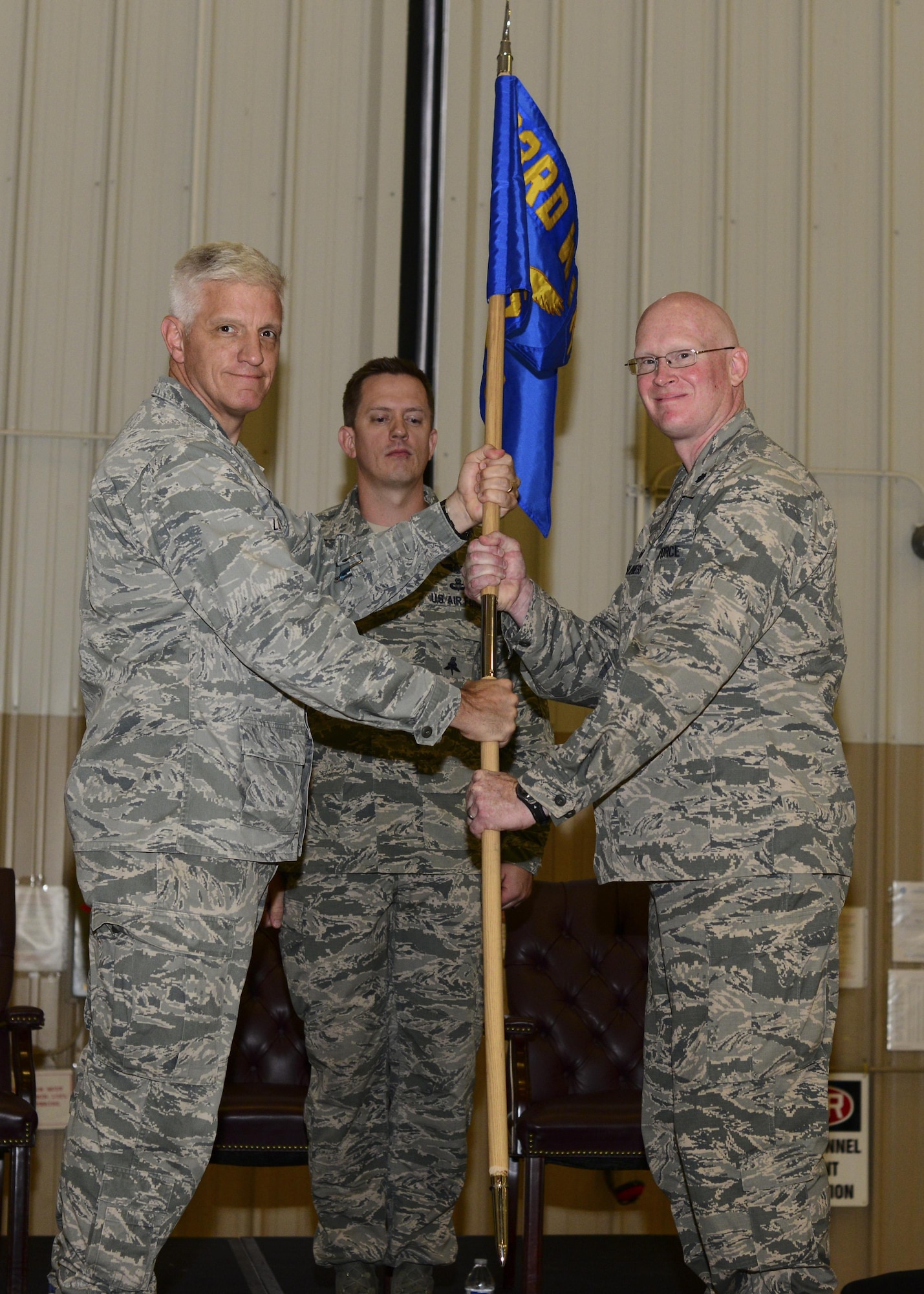 U.S. Air Force Lt. Col. Matthew McGuinness, 68th Rescue Squadron commander, receives the guidon from Col. John Lussier, 563rd Rescue Group commander, during a change of command ceremony at Davis-Monthan Air Force Base, Ariz., June 1st, 2017. Capt. Michael Ellingsen, then-68th Rescue Flight commander, relinquished command to McGuinness at the ceremony and the 68th RQF transitioned to the 68th RQS. (U.S. Air Force photo by Airman 1st Class Nathan H. Barbour)