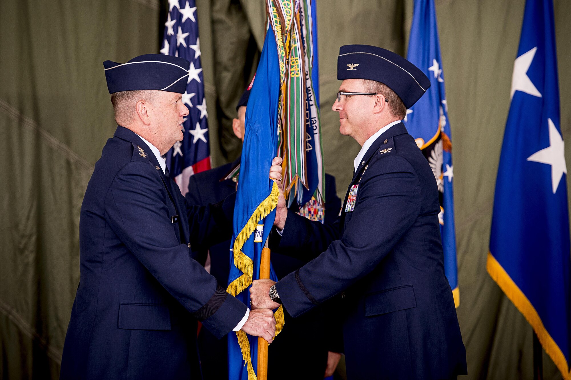 Lt. Gen. Brandon Webb, Air Force Special Operations Command commander, passes on the guidon to incoming 27th Special Operations Wing commander, Col. Stewart Hammons, during his wing's change of command ceremony at Cannon Air Force Base, N.M., Jun. 2, 2017. Col. Benjamin Maitre handed over command of the wing to Hammons. (U.S. Air Force photo by Tech. Sgt. Manuel Martinez)