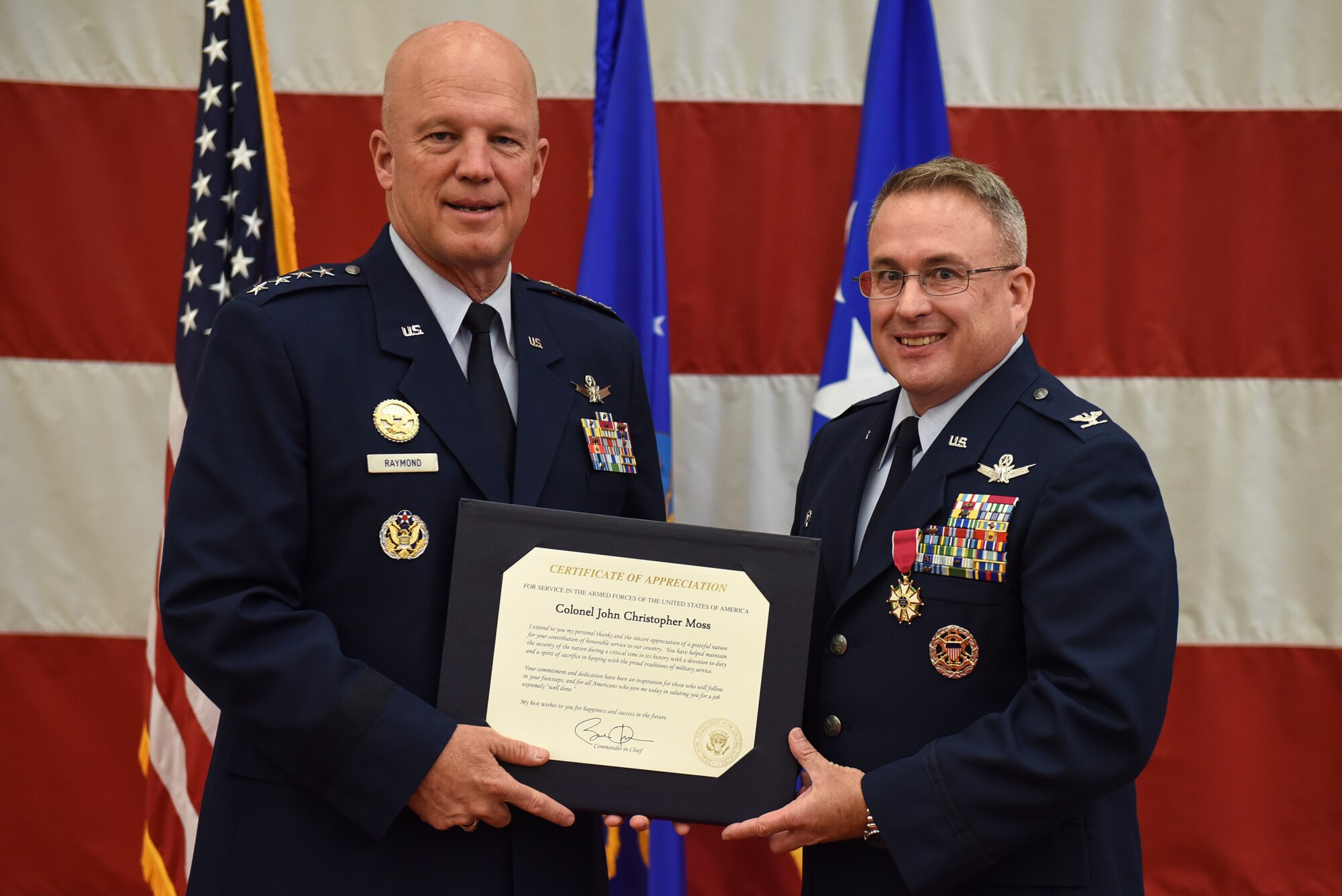 Gen. John W. “Jay” Raymond, commander, Air Force Space Command, presents Col. J. Christopher Moss, 30th Space Wing commander, with a certificate of appreciation during Moss’ retirement ceremony, June 2, 2017, Vandenberg Air Force Base, Calif. Moss served 26 years in the Air Force, including his last two as commander of the 30th SW. (U.S. Air Force photo by Senior Airman Robert J. Volio/Released)