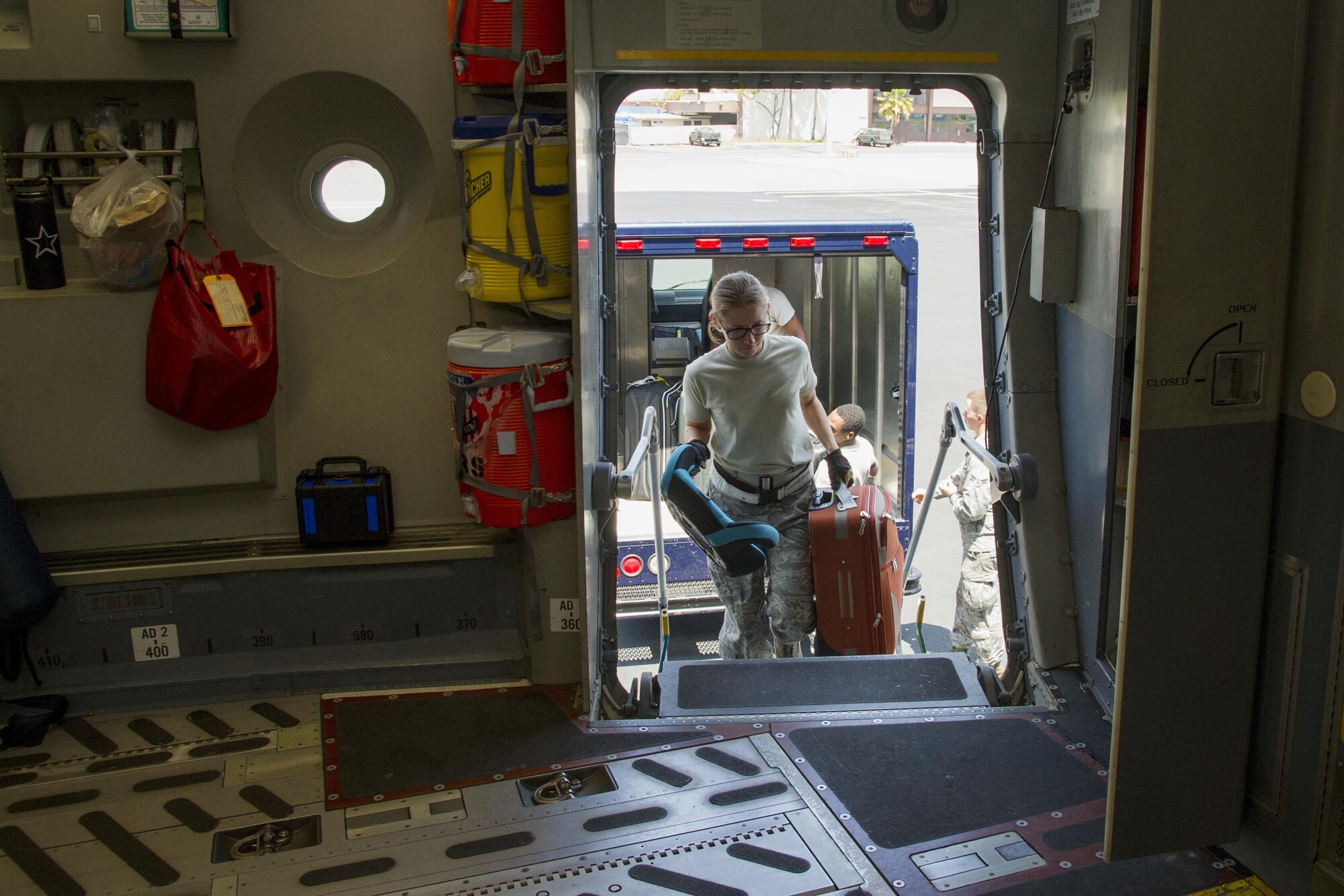 U.S. Air Force Staff Sgt. Jessica Gwinn, a Reserve Citizen Airmen with the 48th Aerial Port Squadron, loads civilian luggage onto a C-17 Globemaster III for a Space Available flight at Joint Base Pearl Harbor-Hickam, Hawaii, March 11, 2017. Members of the 48th Aerial Port Squadron support the Space A Travel program during their two-week annual training and monthly unit training assembly. Located on Oahu and a component of the Air Force Reserve, the 48th Aerial Port Squadron provides expertise in all areas of air terminal operations to include aircraft loading, cargo processing and inspecting, passenger services, aircraft fleet services and aerial port command and control. (U.S. Air Force photo by Master Sgt. Theanne K. Herrmann)
