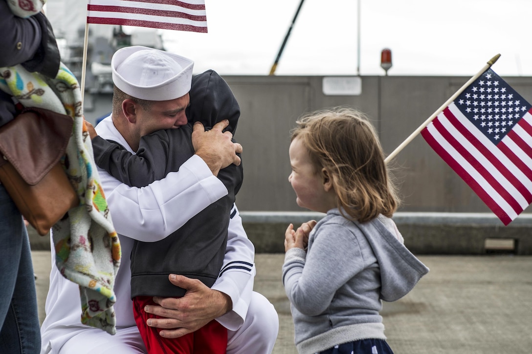 A sailor embraces a family member before departing on the guided missile destroyer USS Shoup in Everett, Wash., June 1, 2017. The Shoup is on a regularly scheduled deployment to the Western Pacific and Indian Oceans as part of the Nimitz Carrier Strike Group. Navy photo by Petty Officer 2nd Class Alex Van’tLeven