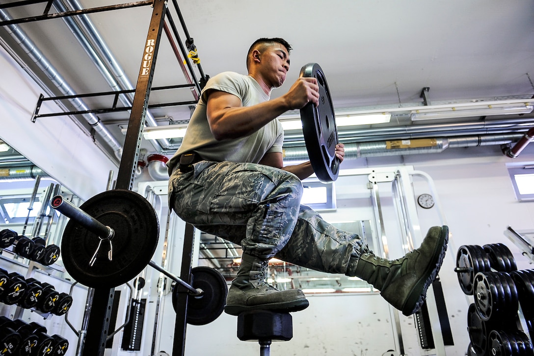 Air Force Airman 1st Class Nikko Madarang balances on one leg and squats while working out at Ramstein Air Base, Germany, June 1, 2017. Madarang is a passenger service specialist assigned to the 721st Aerial Port Squadron. Air Force photo by Airman 1st Class Savannah L. Waters