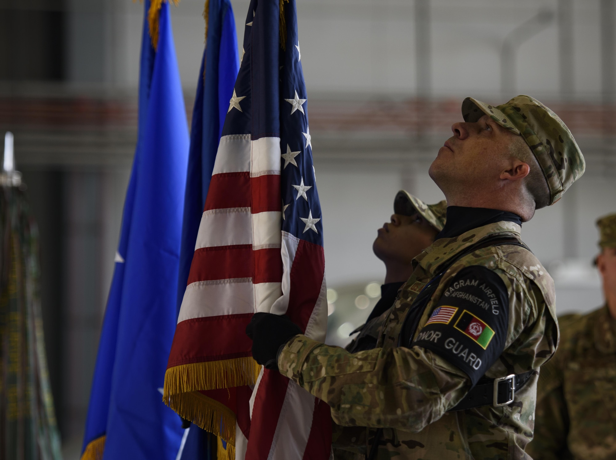 Bagram Honor Guard members set the American and U.S. Air Force flag during a change of command ceremony at Bagram Airfield, Afghanistan, June 3, 2017. During the ceremony, Brig. Gen. Jim Sears relinquished command of the 455th Air Expeditionary Wing to Brig. Gen. Craig Baker. (U.S. Air Force photo by Staff Sgt. Benjamin Gonsier)