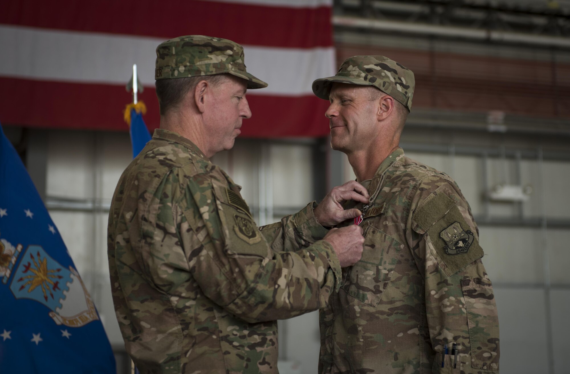 Brig. Gen. Jim Sears, the outgoing 455th Air Expeditionary Wing commander, receives the Bronze Star Medal from Maj. Gen. James Hecker, the 9th Air and Space Expeditionary Task Force-Afghanistan commander, during a change of command ceremony at Bagram Airfield, Afghanistan, June 3, 2017. Sears commanded the 455th AEW for the last 12 months. During his time at Bagram, Sears’ leadership enabled 15,800 combat sorties, accumulating to 102,877 combat hours, which resulted in more than 1,369 kinetic strike and 2,836 enemies killed in action. (U.S. Air Force photo by Staff Sgt. Benjamin Gonsier) 
