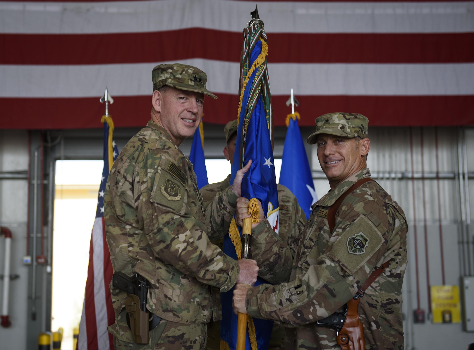 Brig. Gen. Craig Baker, the incoming 455th Air Expeditionary Wing commander, receives the 455th AEW guidon from Maj. Gen. James Hecker, the 9th Air and Space Expeditionary Task Force-Afghanistan commander, which officially grants him command of the 455th AEW during a change of command ceremony at Bagram Airfield, Afghanistan, June 3, 2017. Baker is a command pilot with more than 2,600 flying hours and has commanded at the Squadron and Wing level. (U.S. Air Force photo by Staff Sgt. Benjamin Gonsier) 