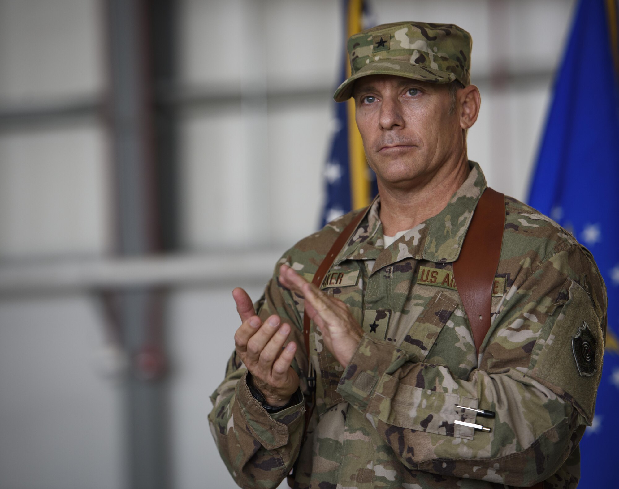 Brig. Gen. Craig Baker, the 455th Air Expeditionary Wing commander, gives a round of applause during a change of command ceremony at Bagram Airfield, Afghanistan, June 3, 2017. As the commander of the 455th AEW, Baker will lead the premier counterterrorism air mission in Afghanistan. The wing’s operations enable the NATO Resolute Support mission to successfully train, advise, and assist the military and security forces of Afghanistan, while restricting and deterring the terrorist threat in the region. (U.S. Air Force photo by Staff Sgt. Benjamin Gonsier)