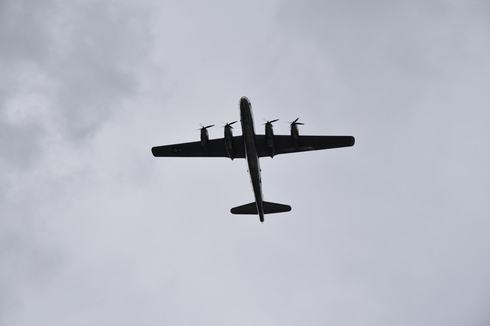 B-29 Superfortress, "Doc," flys over participants of the the Sundown Parade to help kick off Wichita's 2017 Riverfest celebration, June 2, 2017, Wichita, Kan. Team McConnell members took the opportunity throughout the parade to thank community members for their support. (U.S. Air Force photos by Tech. Sgt. Abigail Klein)
