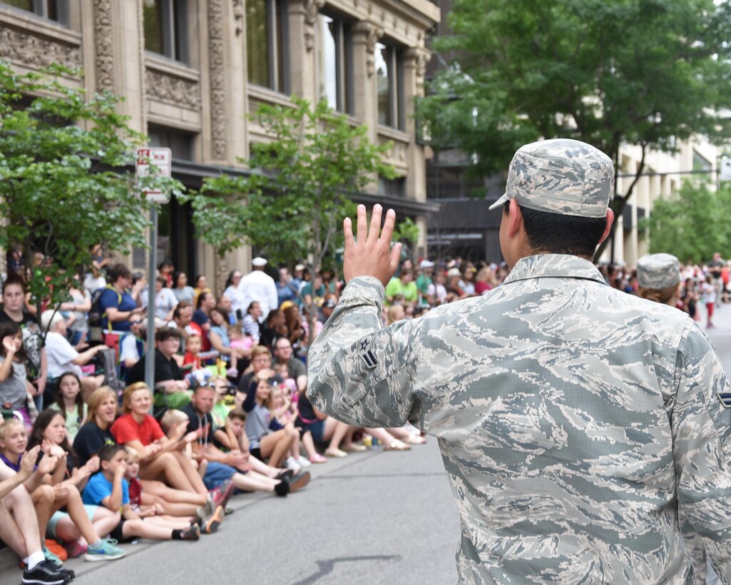 An Airmen from Team McConnell waves at onlookers during Sundown Parade to help kick off Wichita's 2017 Riverfest celebration, June 2, 2017, Wichita, Kan. Team McConnell members took the opportunity throughout the parade to thank community members for their support. (U.S. Air Force photos by Tech. Sgt. Abigail Klein)
