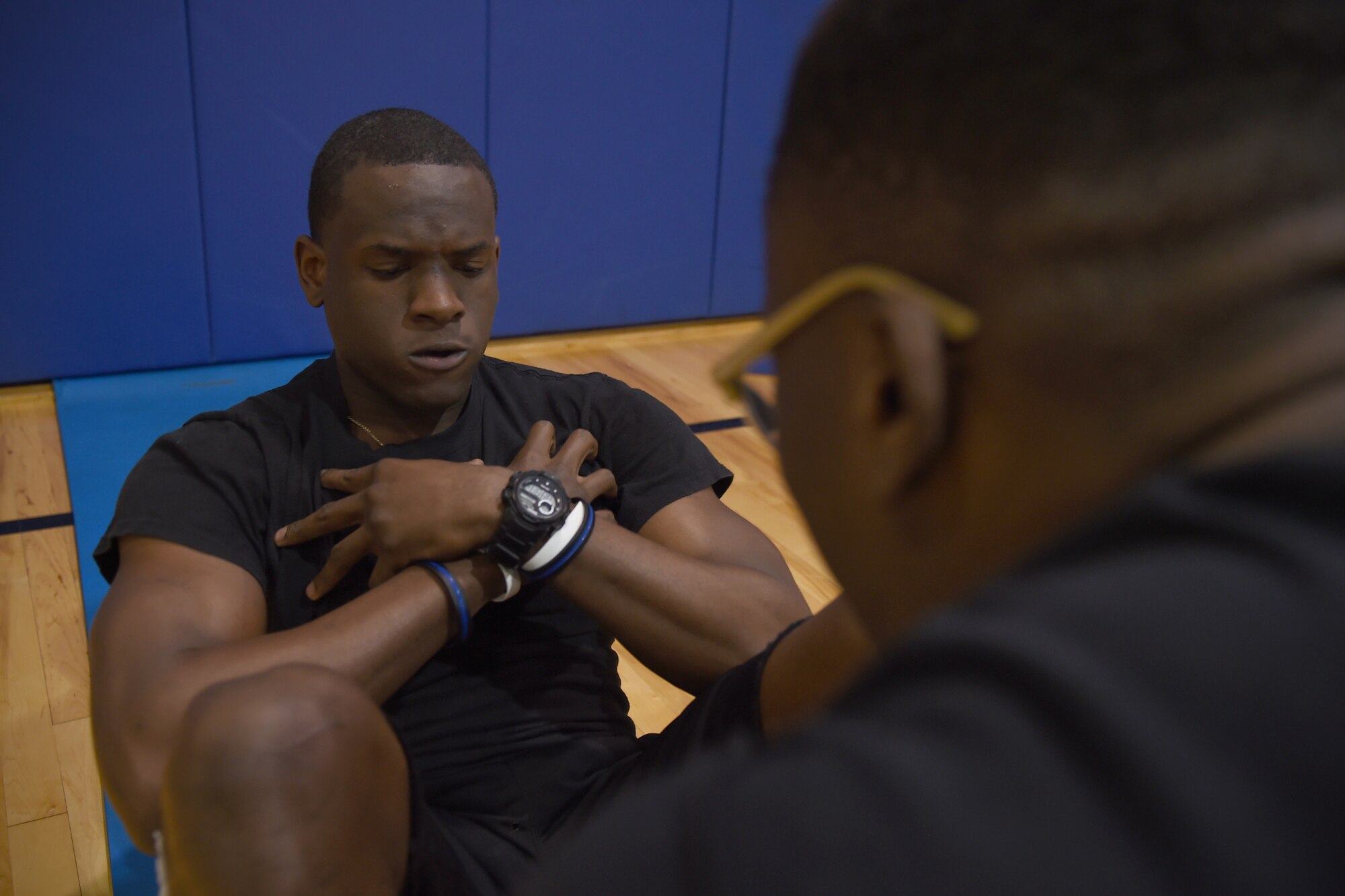 Trainee Clifton Wheeler, 434th Force Support Squadron Development and Training Flight Program member, maxes out the sit-up portion of a mock Air Force physical fitness assessment as trainee Anesu Moyu holds his feet down at Grissom Air Reserve Base, Ind., April 22, 2017. Wheeler and Moyu are both participants of Grissom’s Development and Training Flight, an Air Force Reserve requirement for all trainees before attending Air Force Basic Military Training. (U.S. Air Force photo/Staff Sgt. Katrina Heikkinen)