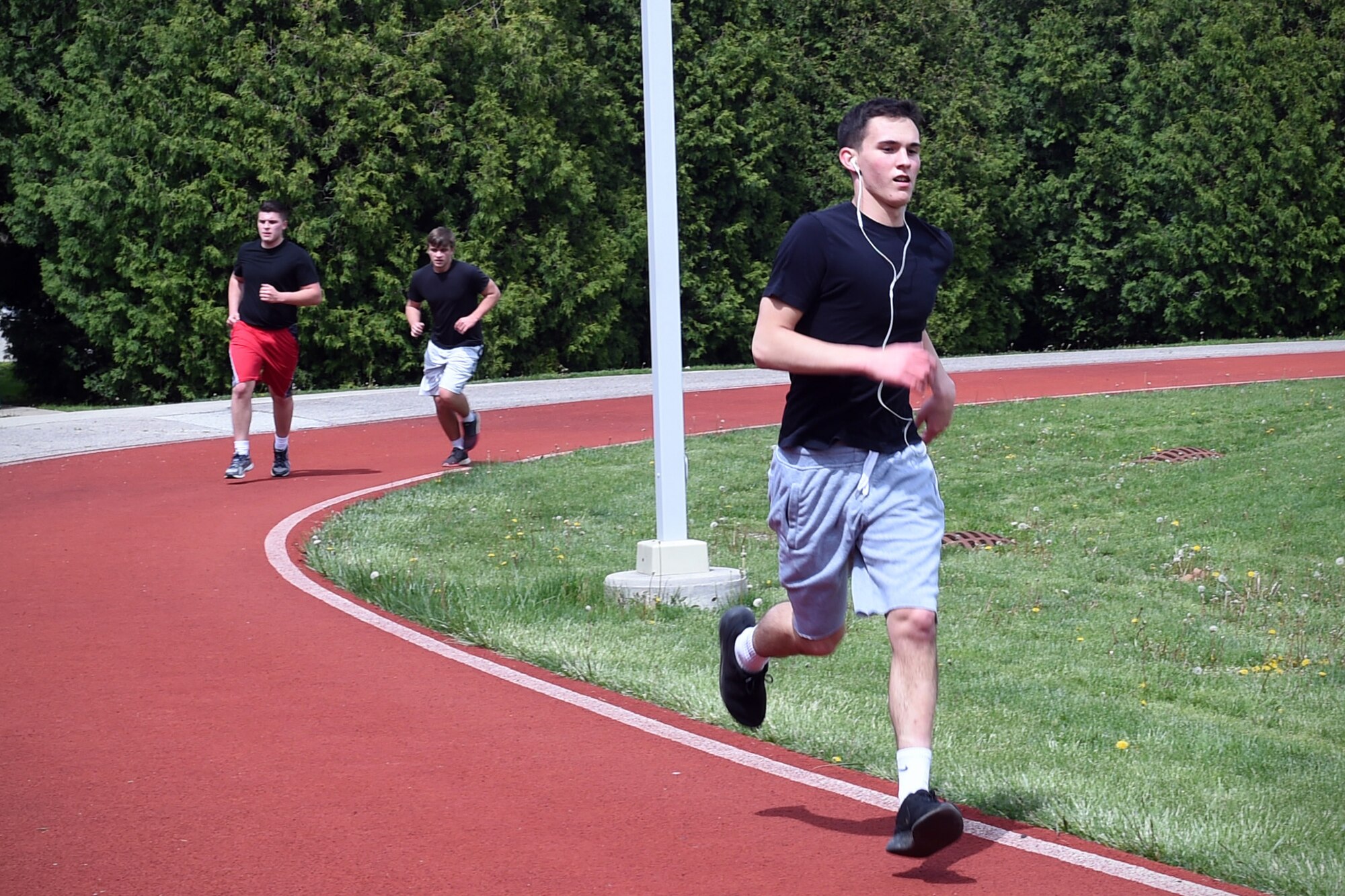 Trainee Gabriel Mota, 434th Force Support Squadron Development and Training Flight Program member, pushes through the last lap of a 1.5-mile run during a mock physical fitness assessment at Grissom Air Reserve Base, Ind., April 22, 2017. Mota, a member of the D&TF Program for six months, will attend Air Force Basic Military Training in August. All trainees are required to pass a PT test before attending BMT. (U.S. Air Force photo/Staff Sgt. Katrina Heikkinen)