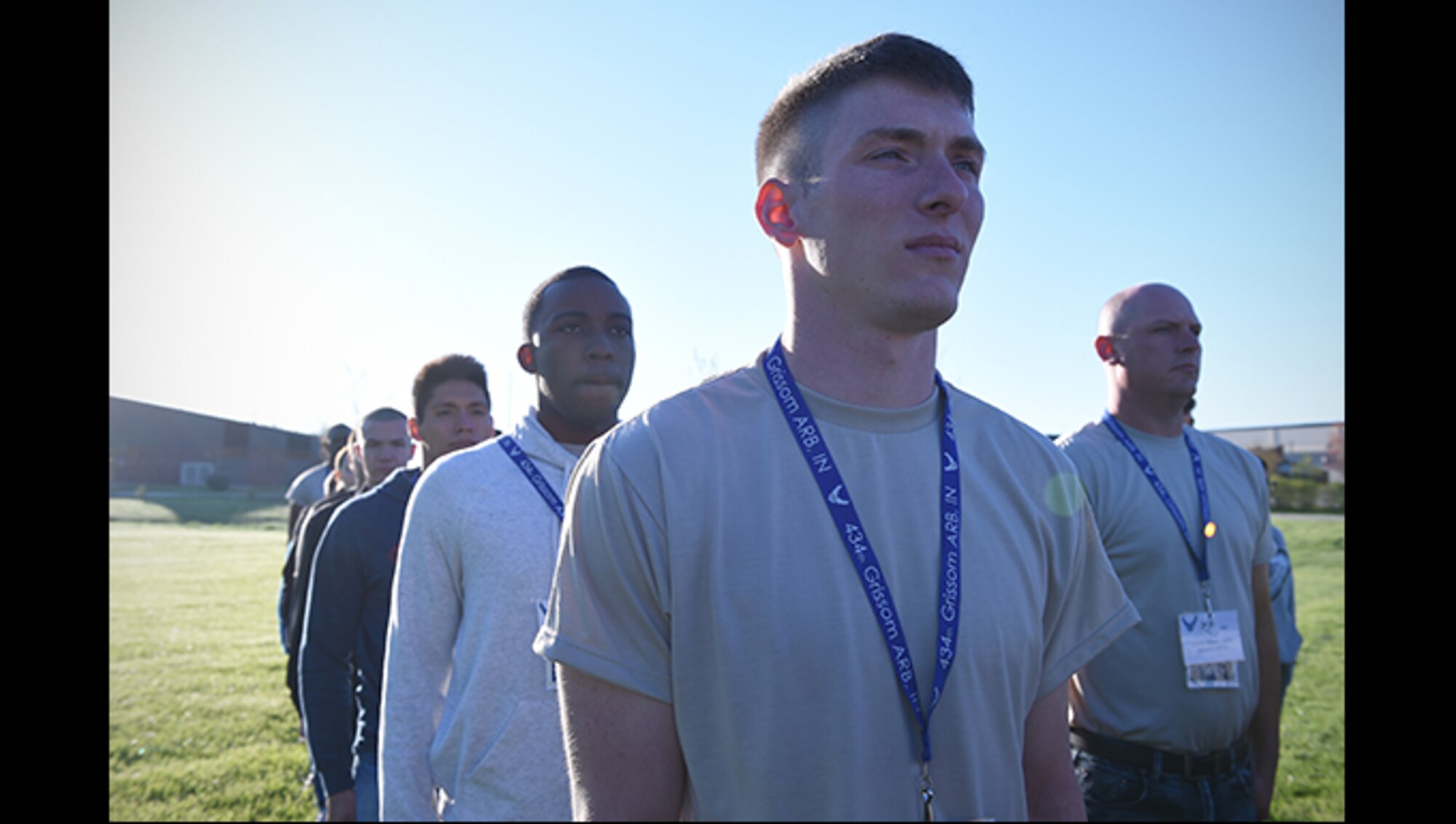 Trainee Travis Bryson (center), 434th Force Support Squadron Development and Training Flight Program member, stands at attention during morning Reveille at Grissom Air Reserve Base, Ind., April 23, 2017. Bryson, along with Jonah Douglas, (center, left), Meza Navarro (second from left) and James Bishop (right) are all members of the 434th FSS Development and Training Flight Program, a program that prepares trainees for Air Force Basic Military Training. (U.S. Air Force photo/Staff Sgt. Katrina Heikkinen)