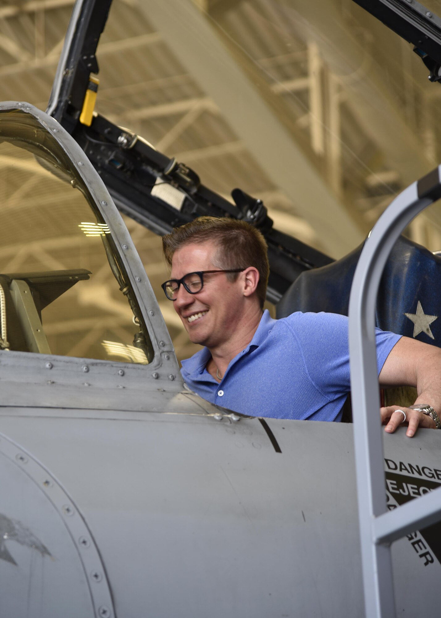 A member of the Office of Cost Assessment and Program Evaluation sits inside the cockpit of an A-10C Thunderbolt II aircraft June 1, 2017, in the fuel cell hangar at Warfield Air National Guard Base, Md. More than 30 CAPE members traveled to Warfield to participate in a base tour and were shown various aspects of the base, including hangers, aircraft and the dining facility. (U.S. Air National Guard photo by Airman Sarah M. McClanahan /Released Master Sgt. Chris Schepers)