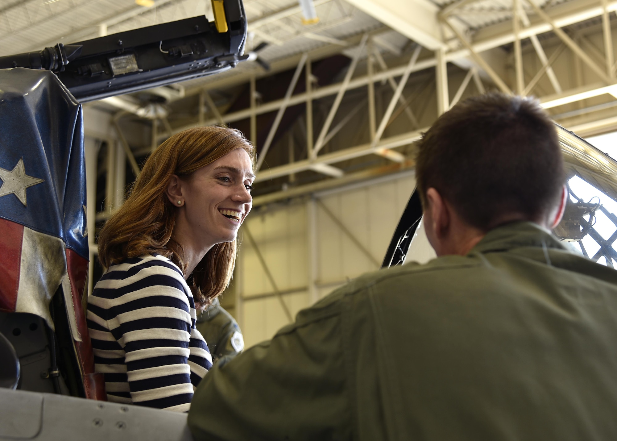 A member of the Office of Cost Assessment and Program Evaluation sits inside the cockpit of an A-10C Thunderbolt II aircraft June 1, 2017, while speaking to a 104th Fighter Squadron pilot in the fuel cell hangar at Warfield Air National Guard Base, Md. As part of a base tour, members were given the opportunity to sit inside an A-10 and learn about the capabilities of the aircraft. (U.S. Air National Guard photo by Airman Sarah M. McClanahan /Released Master Sgt. Chris Schepers)
