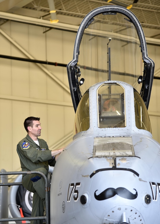 A 104th Fighter Squadron pilot speaks to a member of the Office of Cost Assessment and Program Evaluation June 1, 2017, while seated inside an A-10C Thunderbolt II aircraft in the fuel cell hangar at Warfield Air National Guard Base, Md. The CAPE staff consists of around 160 members which include both government civilians and military officers. (U.S. Air National Guard photo by Airman Sarah M. McClanahan /Released Master Sgt. Chris Schepers)
