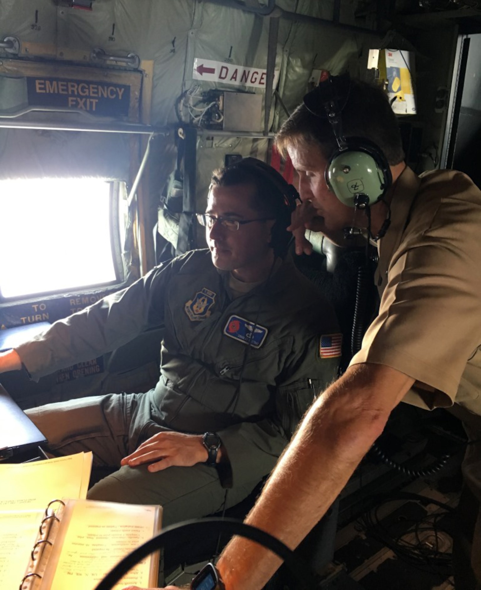 Commander, Naval Meteorology and Oceanography Command and Oceanographer of the Navy Rear Adm. Tim Gallaudet speaks with Maj. Doug Gautrau, 53rd Weather Reconnaissance Squadron aerial reconnaissance weather officer, about his job and the data collected during their mission over the Gulf of Mexico supporting Naval Oceanography Unmanned Systems Operational Demonstration May 31, 2017. (U.S. Navy photo by Kaley Turfitt)