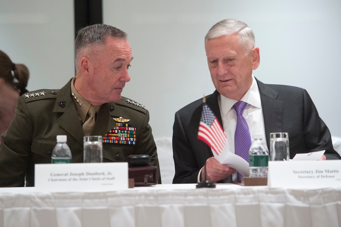 Defense Secretary Jim Mattis and Marine Corps Gen. Joe Dunford, chairman of the Joint Chiefs of Staff, consult while meeting with members of the Australian and Japanese defense delegation during the Shangri-La Dialogue in Singapore, June 3, 2017. DoD photo by Navy Petty Officer 2nd Class Dominique A. Pineiro