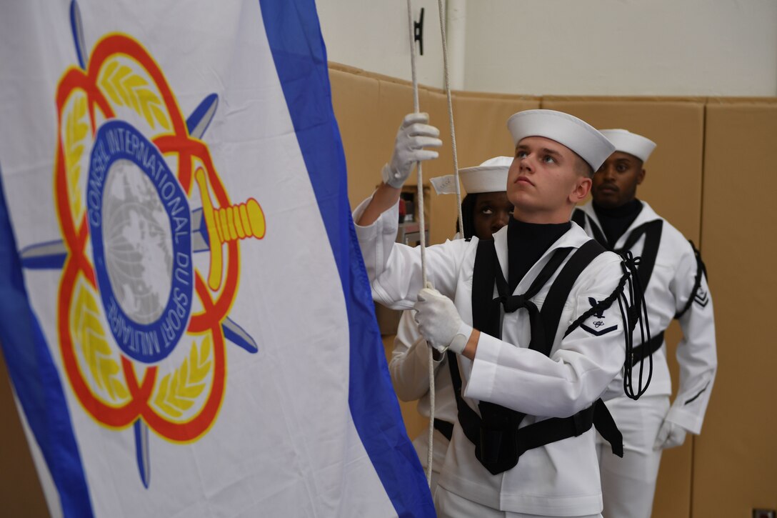 170603-N-UK306-083 JACKSONVILLE, Fla. (June 3, 2017)  The color guard raises the official tournament flag during opening ceremony of the 18th Conseil International du Sport Militaire (CISM) World Military Women's Volleyball Championship at Naval Station Mayport.  Teams from the United States, Canada, China, Germany and The Netherlands will compete June 4-9, while promoting peace activities and solidarity among athletes. (U.S. Navy photo by Mass Communication Specialist 2nd Class Timothy Schumaker/Released)