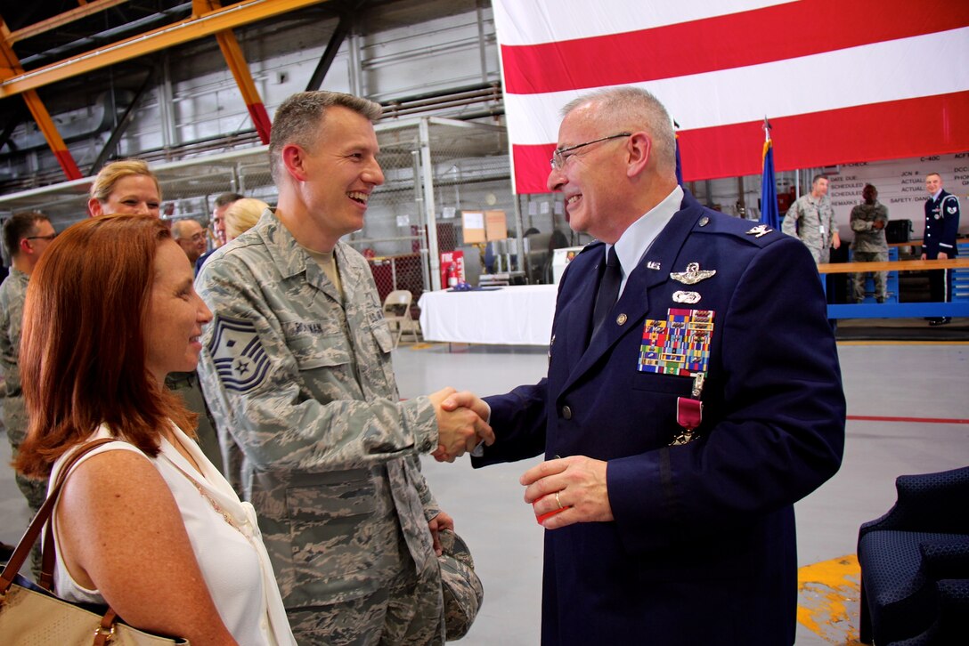 932nd Airlift Wing First Sergeant, Senior Master Sgt. Brian Rohlman, congratulates his commander, Col. Jonathan Philebaum, as he retires on June 3, 2017, at Scott Air Force Base, Illinois.  Friends and family from around the nation came to the 932nd Airlift Wing "Gateway Wing", to see the retiring commander's last day, and to thank him for more than 31 years of faithful service to the United States Air Force and Air Force Reserve Command.  (U.S. Air Force photo by Lt. Col. Stan Paregien)