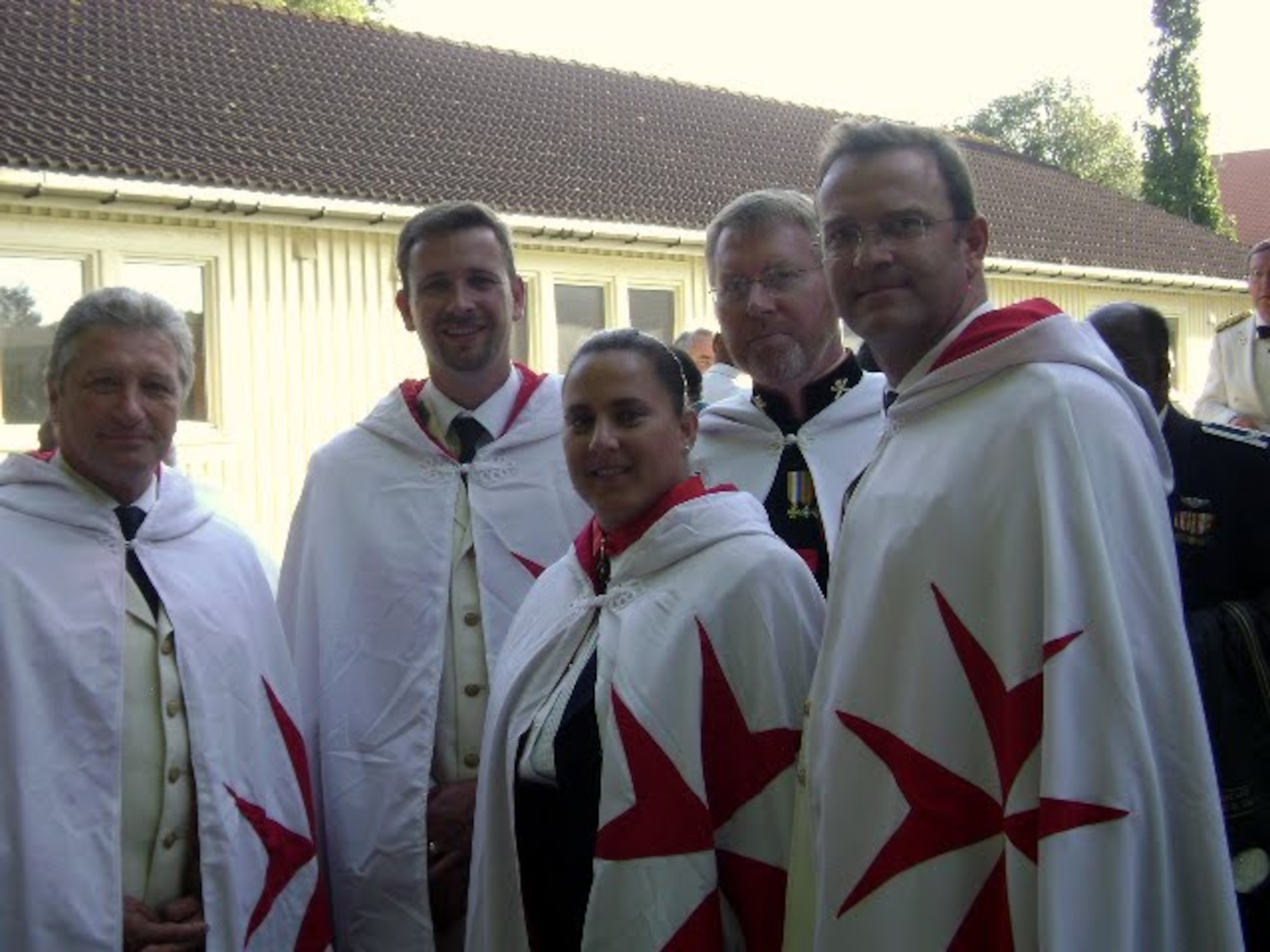 Dame Zohe Quintero (middle), a captain with the 920th Force Support Squadron, poses for a photo with members who were knighted by the Sovereign Military Order of the Temple of Jerusalem. (Courtesy photo) 