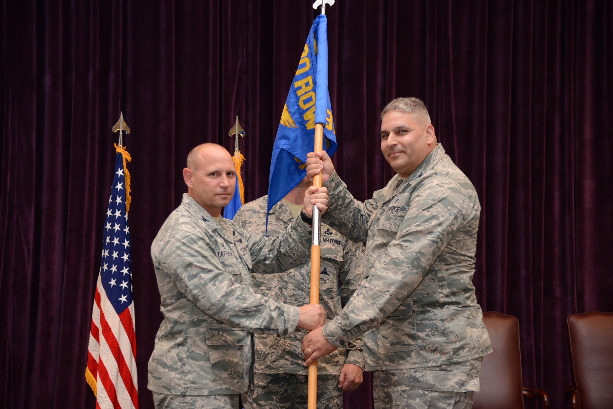 Col. Kurt Matthews (right), 920th Rescue Wing commander, hands the 920th Operations Group guidon to Col. Michael Loforti, during an assumption of command ceremony, June 3, 2017 at Patrick Air Force Base, Florida. (U.S. Air Force photo/Staff Sgt. Jared Trimarchi) 