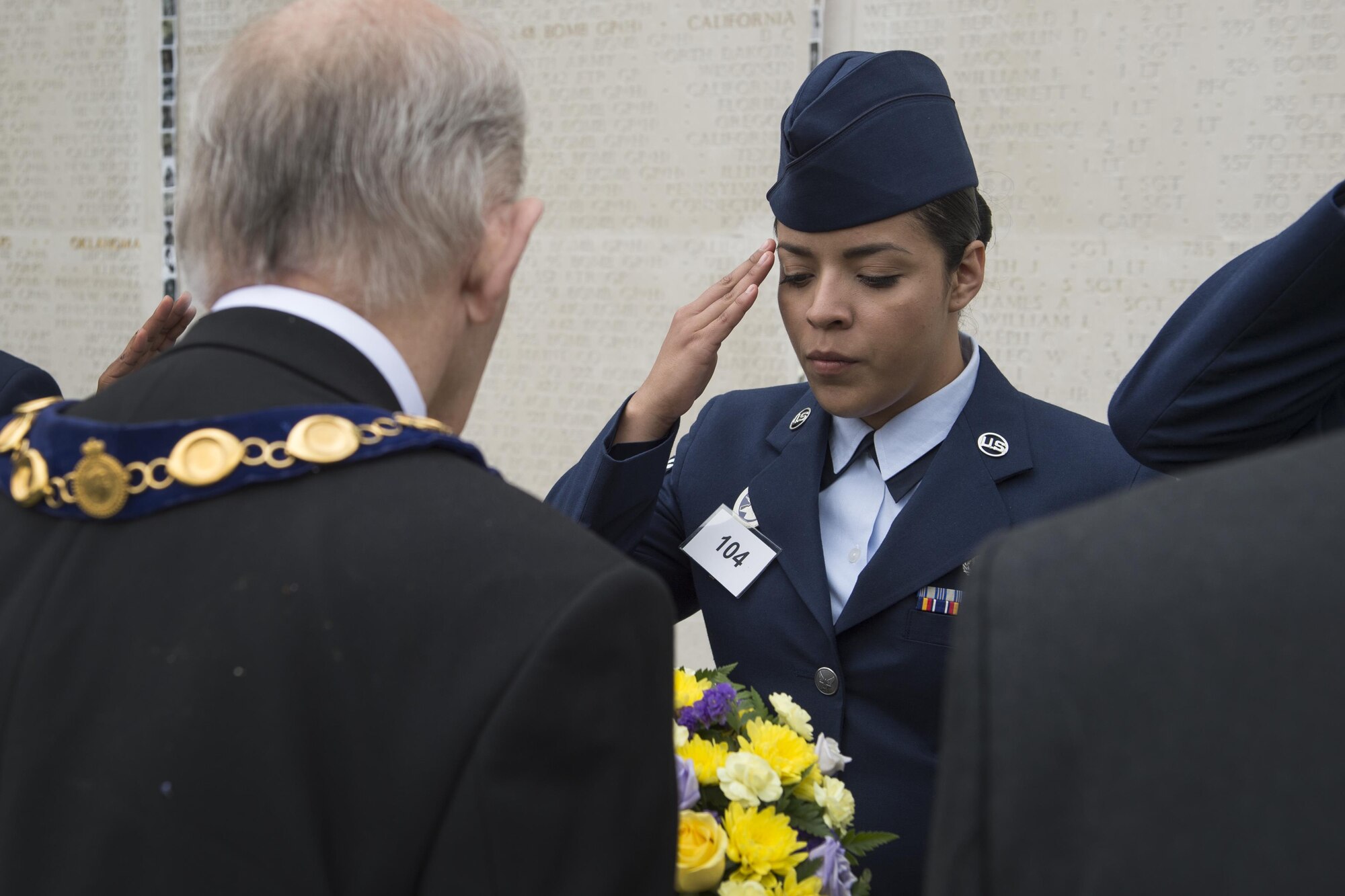 Senior Airman Stephanie Briones, Grissom base honor guard manager, salutes a British veteran after passing a wreath symbolizing the continued unity between the two nations during a Memorial Day ceremony at the Cambridge American Cemetery in Cambridge, England May 29, 2017. Briones and 19 other individuals from Grissom were selected to attend the event to learn more about the unit’s history and heritage. (U.S. Air Force photo/Tech. Sgt. Benjamin Mota)