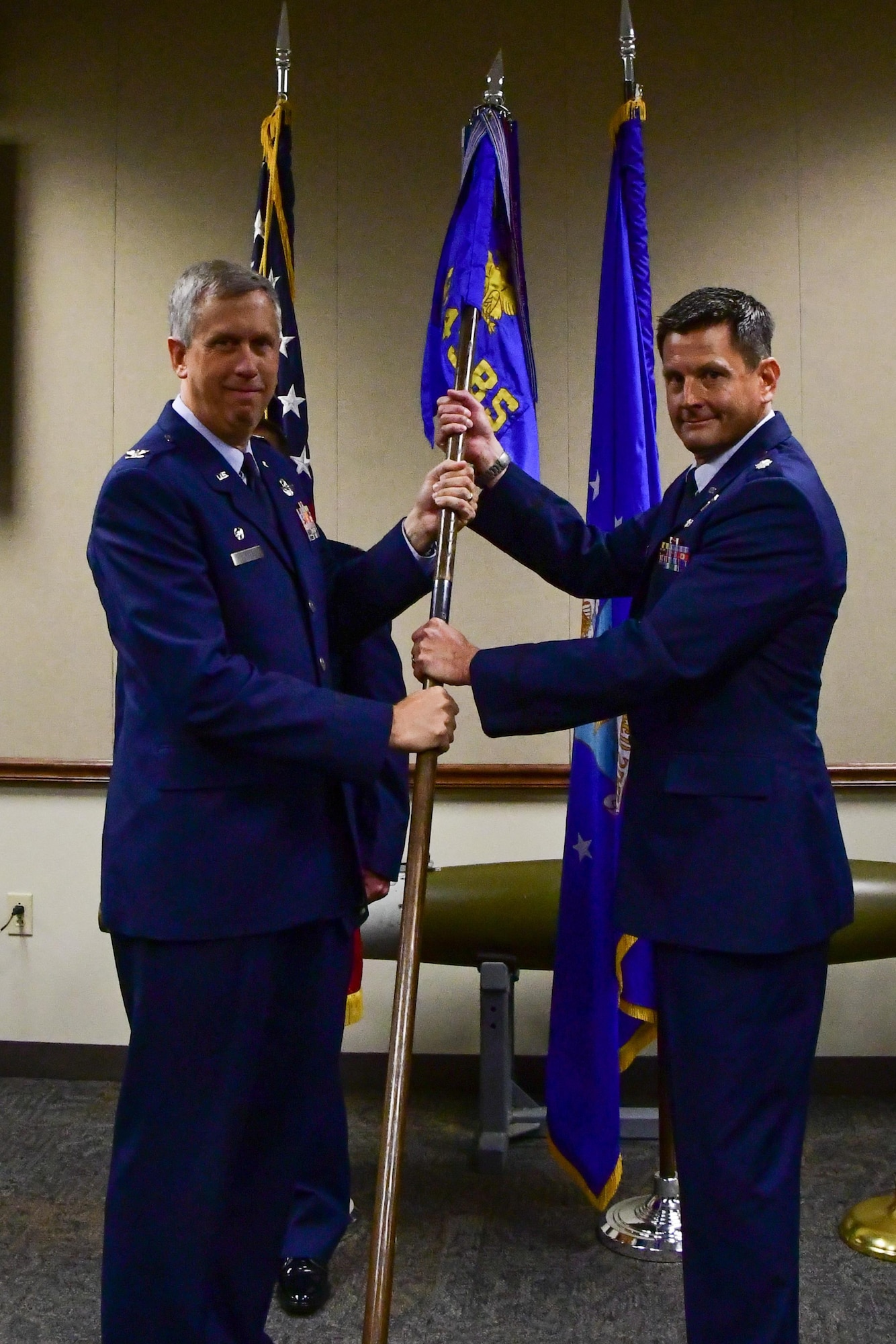 U.S. Air Force Col. Robert N. Burgess, 307th Operations Group commander, presents the guidon of the 343rd Bomb Squadron to Lt. Col. John P. Booker during a change of command ceremony at Barksdale Air Force Base, La., June 3, 2017. Booker is assuming command of the only Air Force Reserve nuclear certified bomb squadron. (U.S. Air Force photo by Master Sgt. Dachelle Melville/Released)