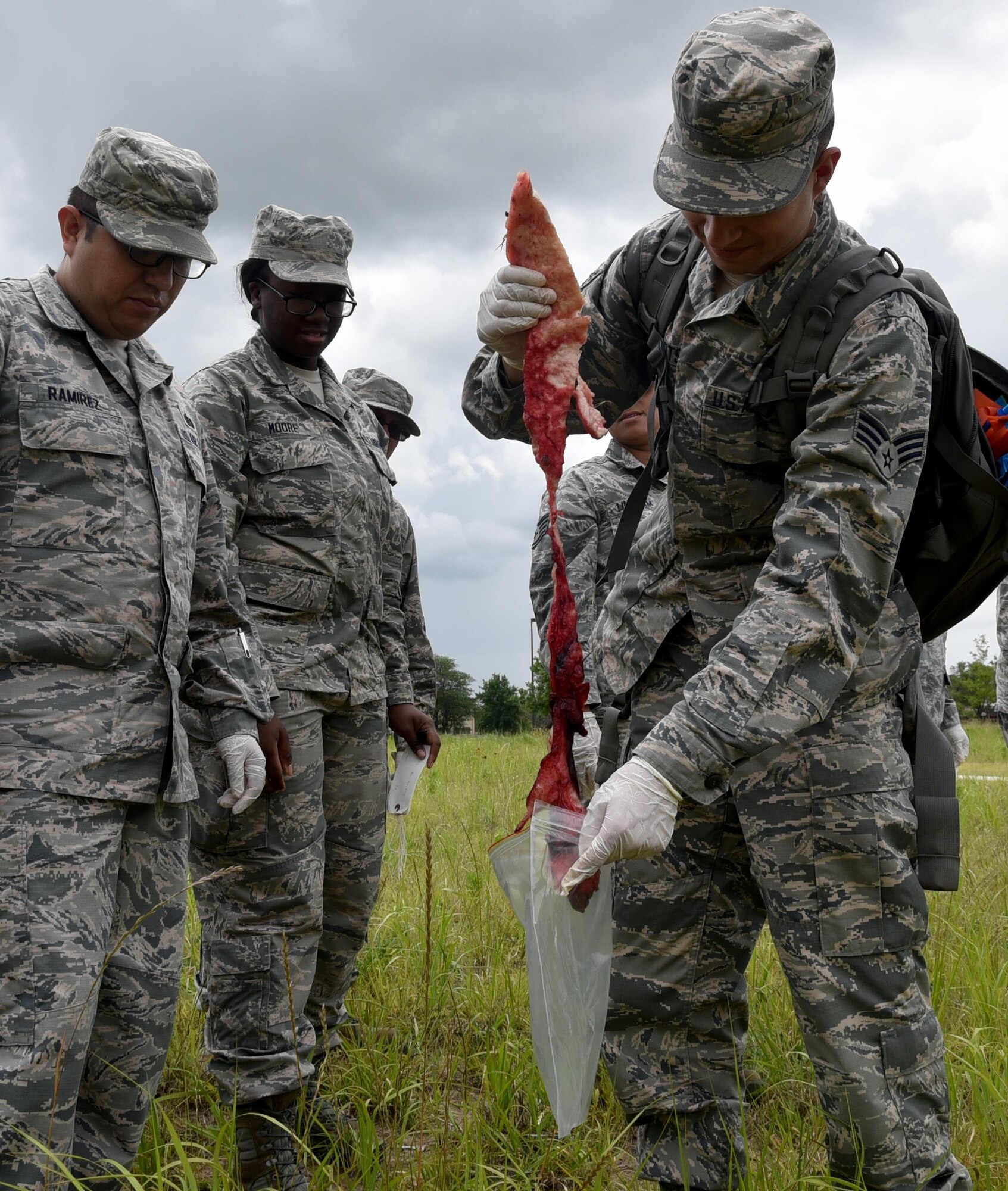 Team McConnell Force Support Squadron Airmen collect "debris" from a simulated crash site, June, 3, 2017, at McConnell Air Force Base, Kan.  Airmen of the 931st and 22nd Force Support Squadron teamed for the first time for a Search and Recovery Exercise.The exercise is an annual requirement for all FSS Airmen and is part of their Mortuary Affairs training.  The class consisted of six Reserve and eight active duty Airmen.  (U.S. Air Force photo by Tech. Sgt. Abigail Klein)
