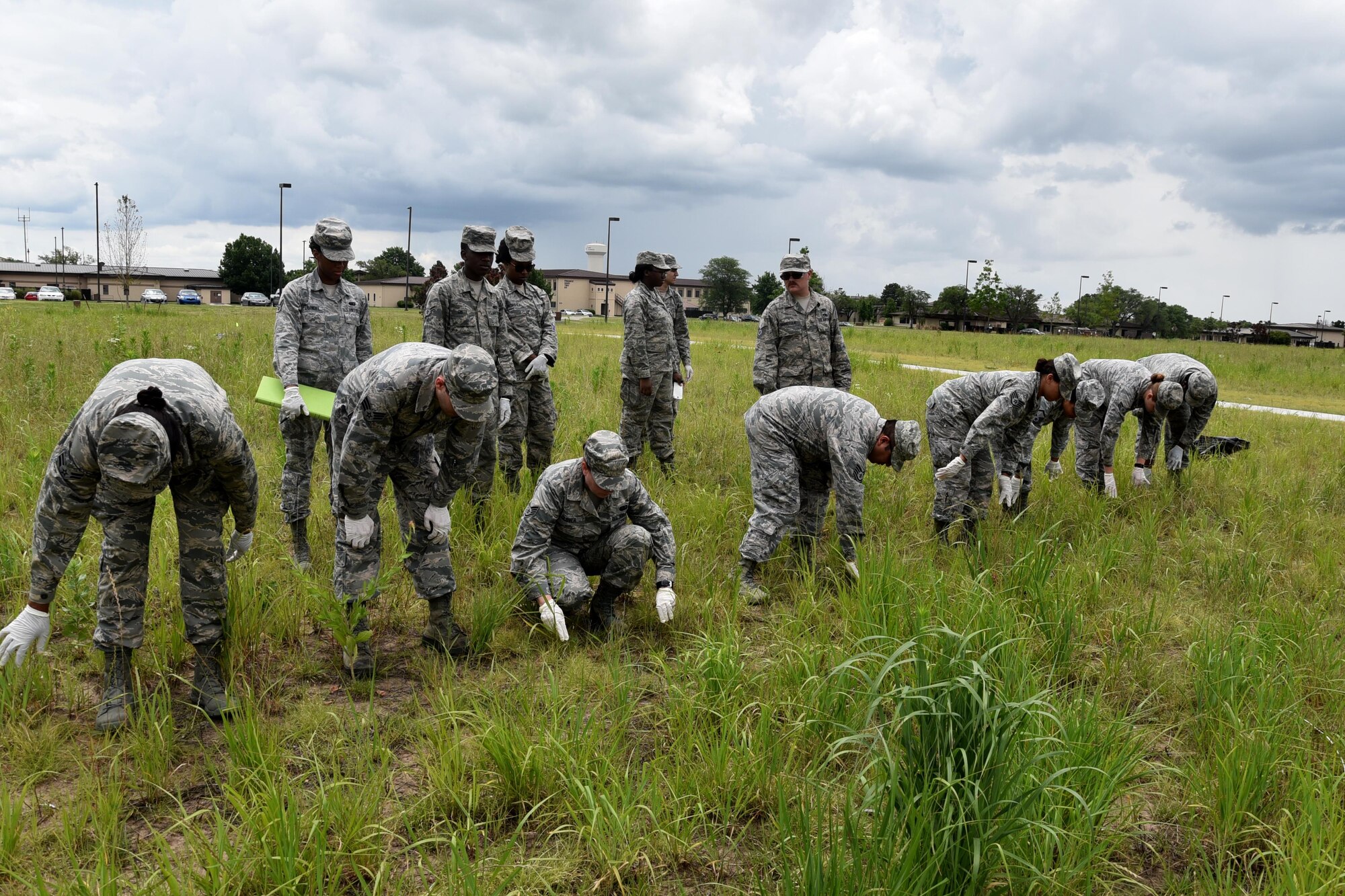 Team McConnell Force Support Squadron Airmen collect "debris" at a simulated crash site, June 3, 2017, at McConnell Air Force Base, Kan.  Airmen of the 931st and 22nd Force Support Squadron teamed for the first time for a Search and Recovery Exercise. The exercise is an annual requirement for all FSS Airmen and is part of their Mortuary Affairs training.  The class consisted of six Reserve and eight active duty Airmen.  (U.S. Air Force photo by Tech. Sgt. Abigail Klein)
