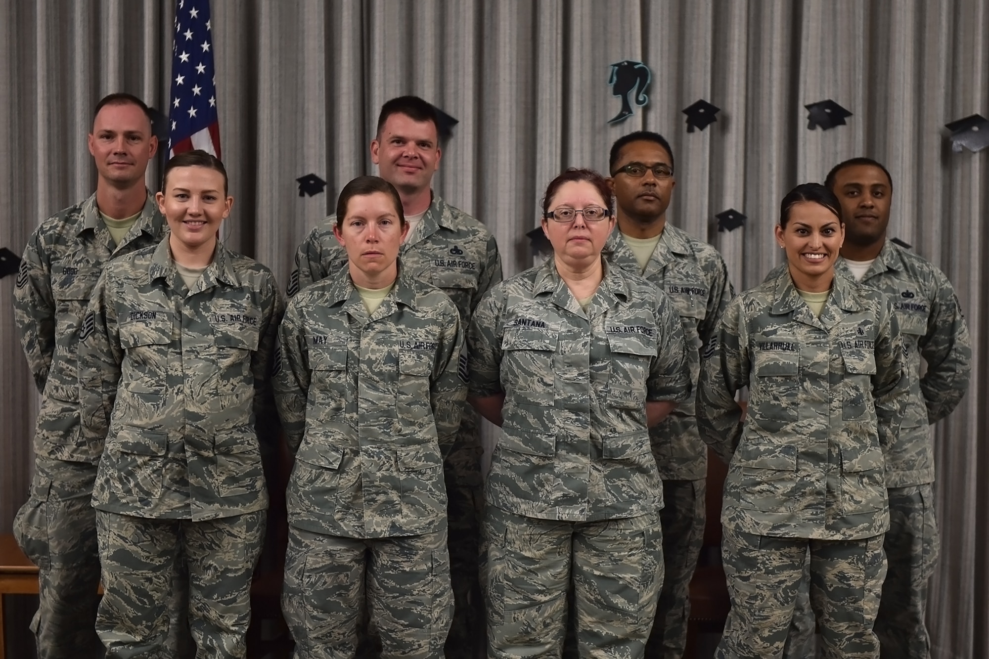 Community College of the Air Force graduates pose for a photo during a CCAF graduation ceremony at Grissom Air Reserve Base, Ind., June 4, 2017. The college annually awards over 22,000 associate degrees from 68 degree programs to Air Force members. (U.S. Air Force photo/Staff Sgt. Jami K. Lancette)