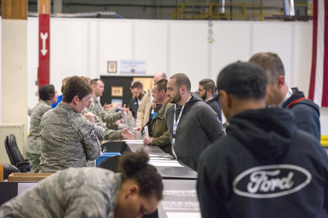 Reservists from the 446th Airlift Wing talk with Civilian Employers in a deployment processing line at McChord Field June 3, 2017, during Employer Orientation Day. Reservists invited their employers out for a day to learn and experience life in the Air Force Reserve. Employers went through a deployment processing line and took part in a training flight aboard a C-17 Globemaster III, which included an airdrop. (U.S. Air Force photo by Tech. Sgt. Bryan Hull)