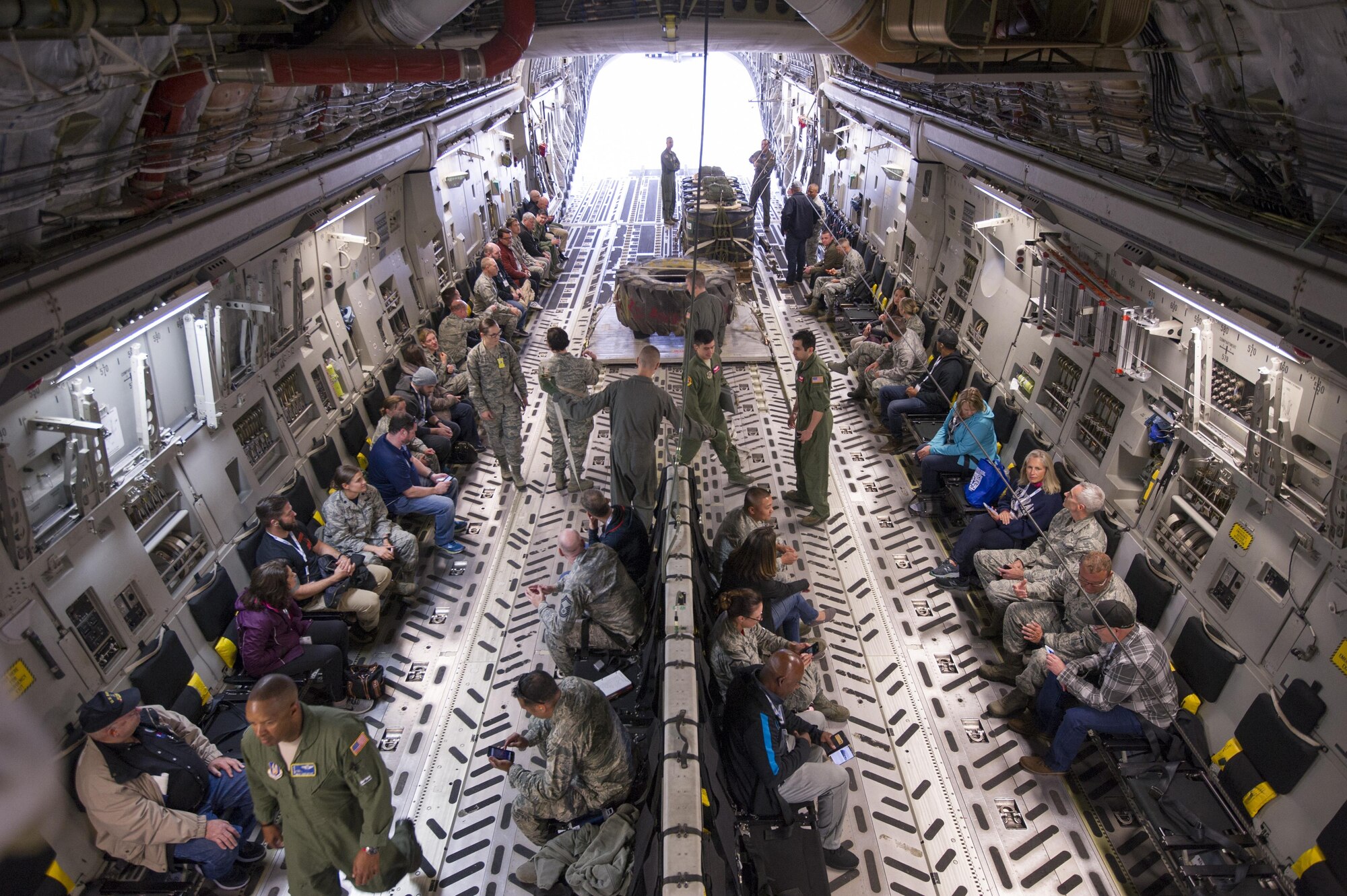 Civilian employers and their reservists sit aboard a C-17 Globemaster III at McChord Field June 3, 2017, while the air crew prep the airplane for take-off during Employer Orientation Day. Reservists invited their employers out for a day to learn and experience life in the Air Force Reserve. Employers went through a deployment processing line and took part in a training flight aboard a C-17 Globemaster III, which included an airdrop. (U.S. Air Force photo by Tech. Sgt. Bryan Hull)