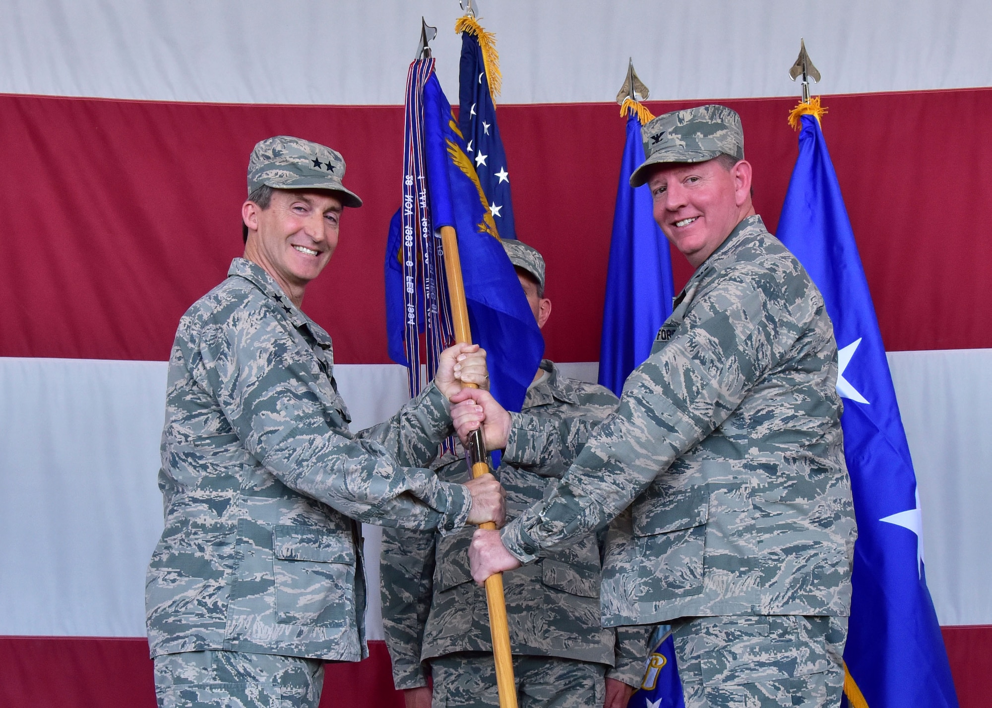 Maj. Gen. Ronald Miller, 10th Air Force commander, hands the 944th Fighter Wing guidon to Col. Bryan Cook Jun 3 during the 944th Fighter Wing Change-of-Command ceremony at Luke Air Force Base, Ariz. (U.S. Air Force photo by Tech. Sgt. Louis Vega Jr.)