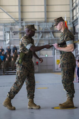 U.S. Marine Corps Sgt. Maj. Darnell Richardson, outgoing Headquarters and Headquarters Squadron (H&HS) sergeant major, commences the passing of the sword of office to Lt. Col. Kevin A. Campbell, commanding officer of H&HS at Marine Corps Air Station Iwakuni, Japan, June 2, 2017. A relief and appointment ceremony was held to welcome the incoming and see off the outbound sergeant major. (U.S. Marine Corps photo by Lance Cpl. Joseph Abrego)