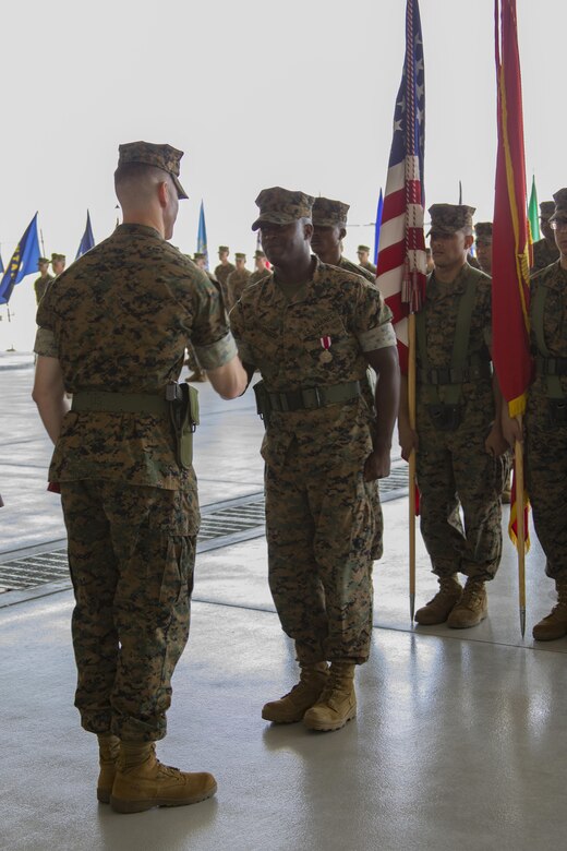 U.S. Marine Corps Lt. Col. Kevin A. Campbell, left, commanding officer of Headquarters and Headquarters Squadron (H&HS), shakes hands with Sgt. Maj. Darnell Richardson, right, during a relief and appointment ceremony at Marine Corps Air Station Iwakuni, Japan, June 2, 2017. The relief and appointment ceremony was held to welcome the incoming and see off the outbound sergeant major. (U.S. Marine Corps photo by Lance Cpl. Joseph Abrego)