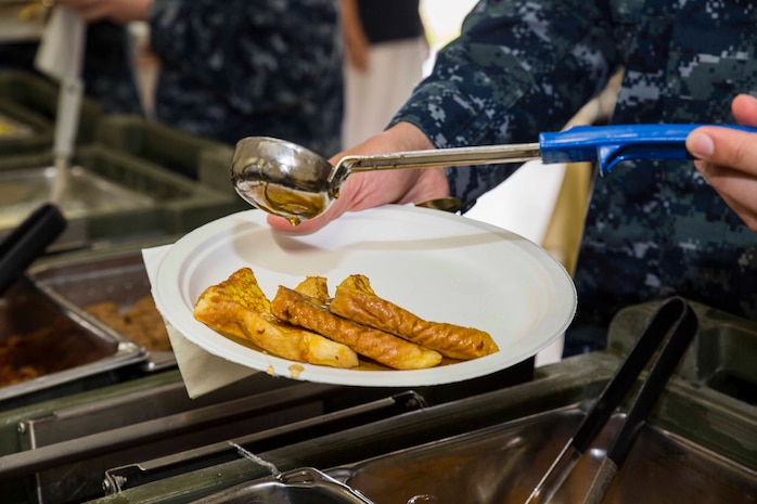 Service members enjoy breakfast during an awards ceremony for the Active-Duty Fund Drive (ADFD) in support of the Navy-Marine Corps Relief Society (NMCRS) at Marine Corps Air Station Iwakuni, Japan, June 1, 2017. The ceremony acknowledged Marines and Sailors for their contribution to the NMCRS ADFD. The NMCRS is a non-profit organization that runs solely on donation. It gives financial, educational and other need-based assistance to active-duty and retired Sailors and Marines and their families. (U.S. Marine Corps photo by Lance Cpl. Gabriela Garcia-Herrera)