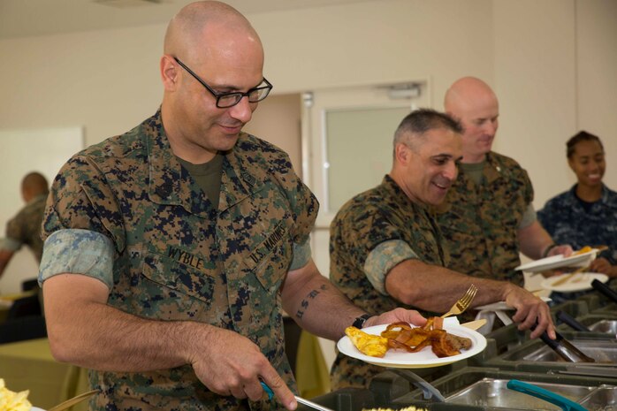 U.S. Marine Corps Sgt. Maj. Johnathan Wyble, sergeant major of Marine Wing Support Squadron (MWSS) 171, serves himself breakfast during an awards ceremony for the Active-Duty Fund Drive (ADFD) in support of the Navy-Marine Corps Relief Society (NMCRS) at Marine Corps Air Station Iwakuni, Japan, June 1, 2017. The ceremony acknowledged Marines and Sailors for their contribution to the NMCRS ADFD. The NMCRS is a non-profit organization that runs solely on donations. It gives financial, educational and other need-based assistance to active-duty and retired Sailors and Marines and their families. (U.S. Marine Corps photo by Lance Cpl. Gabriela Garcia-Herrera)