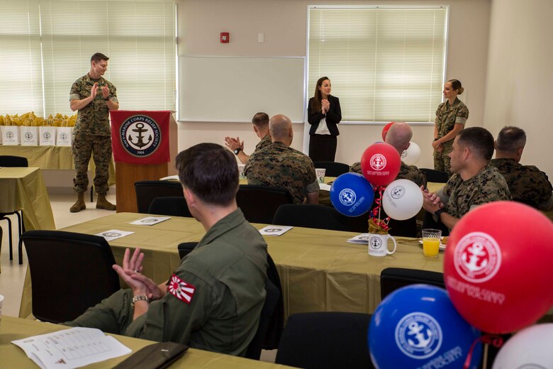 U.S. Marine Corps Lt. Col. Kevin A. Campbell, commanding officer of Headquarters and Headquarters Squadron, left, addresses U.S. Marine Corps 1st Lt. Melissa Heisterberg, deputy director of the public affairs office with H&HS, right, for her hard work and dedication as the active-duty fund drive (ADFD) coordinator during an award ceremony for the ADFD in support of the Navy-Marine Corps Relief Society (NMCRS) at Marine Corps Air Station Iwakuni, Japan, June 1, 2017. The ceremony acknowledged Marines and Sailors for their contribution to the NMCRS ADFD. The NMCRS is a non-profit organization that runs solely on donations. It gives financial, educational and other need-based assistance to active-duty and retired Sailors and Marines and their families. MCAS Iwakuni raised $127,672.98, making it the Marine Corps installation that raised the most money per capita for the NMCRS for the year. (U.S. Marine Corps photo by Lance Cpl. Gabriela Garcia-Herrera)