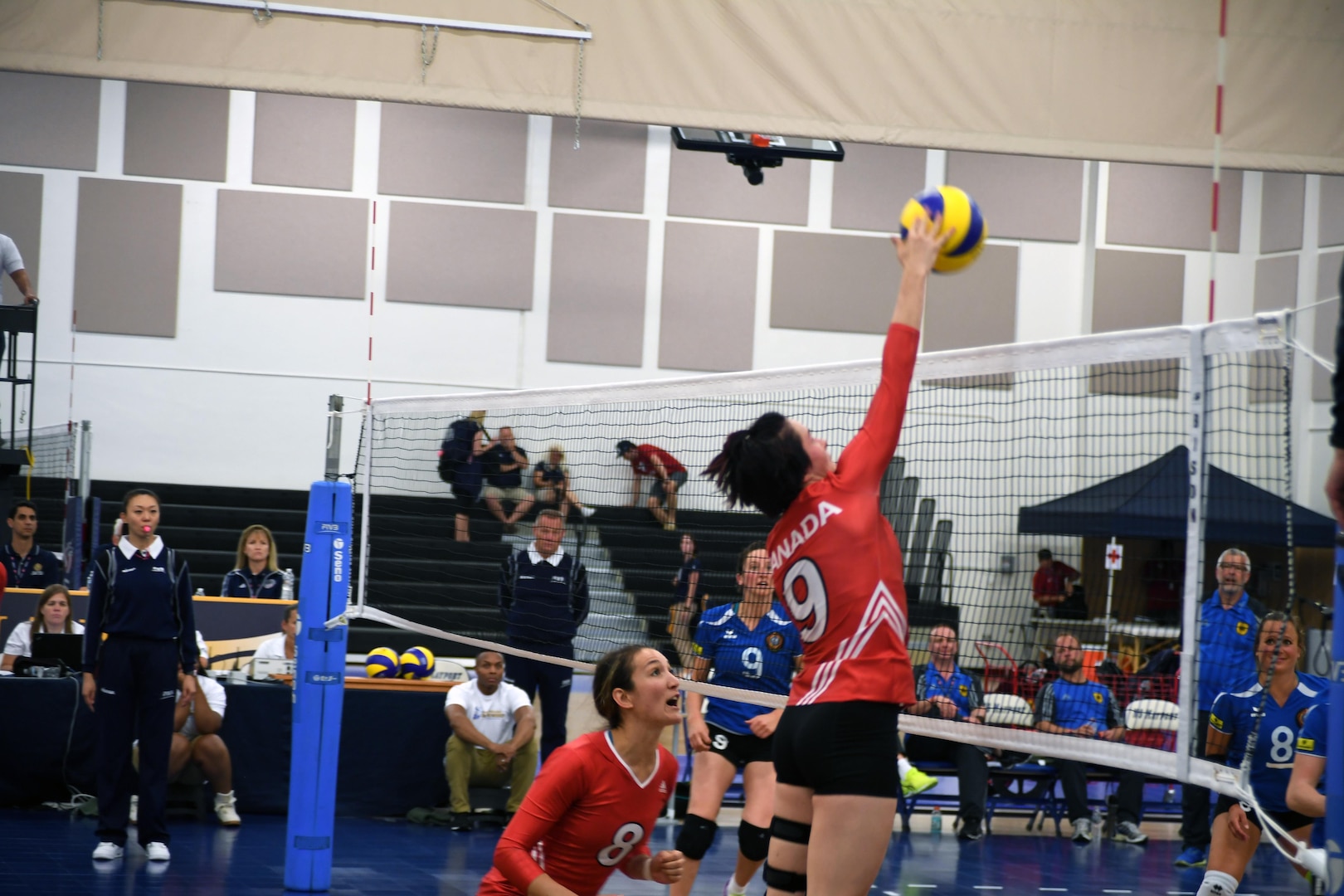AB Norah Collins (#9) of Canada spikes the ball in their match against Germany of the 18th Conseil International du Sport Militaire (CISM) World Women's Military Volleyball Championship at Naval Station Mayport, Florida on 4 June 2017. Mayport is hosting the CISM Championship from 2-11 June.  Finals are on 9 June.