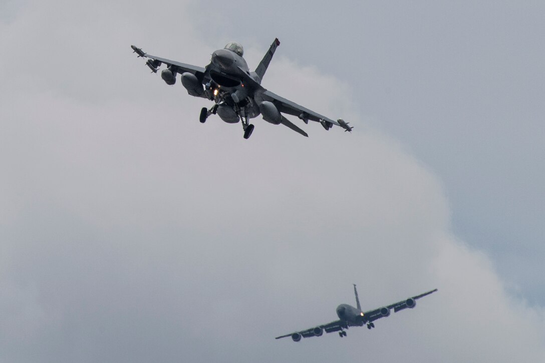 An F-16 Fighting Falcon assigned to the 36th Fighter Squadron, Osan Air Base, Republic of Korea and a KC-135R Stratotanker from the 91st Air Refueling Squadron, MacDill Air Force Base, Fla., prepare to land at Yokota Air Base, Japan, June 1, 2017. Fifteen F-16s and KC-135R landed at Yokota en route to Alaska to participate in exercise Red Flag. (U.S. Air Force photo by Yasuo Osakabe/Released)