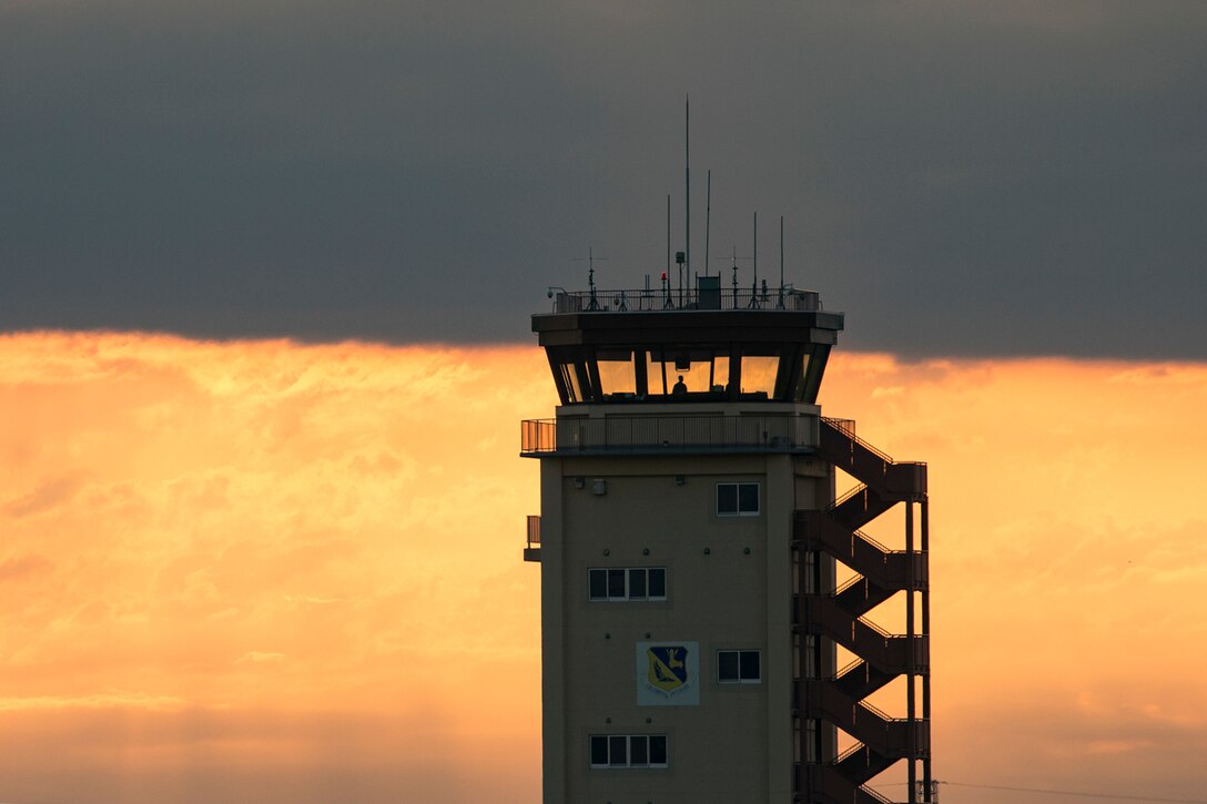 An air traffic controller with the 374th Operations Support Squadron looks out from the control tower at Yokota Air Base, Japan, June 4, 2017. Airmen with the 374th OSS keep yokota’s flightline and sky safe. (U.S. Air Force photo by Yasuo Osakabe)