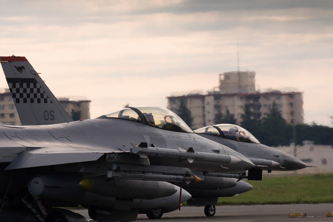 Two F-16 Fighting Falcons assigned to the 36th Fighter Squadron, Osan Air Base, Republic of Korea wait to taxi on the flightline at Yokota Air Base, Japan, June 4, 2017. Fifteen F-16’s transited to Yokota en route to Alaska. (U.S. Air Force photo by Yasuo Osakabe)