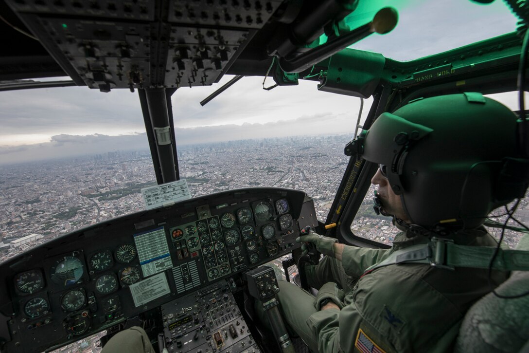 Col. Robert Dotson, 374th Operations Group commander, flies over Tokyo during his fini flight, May 25, 2017. Known as “fini flight,” military aviators have a tradition where after completion of their final flight, aircrew members are met and hosed down with water by their group comrades, family and friends. (U.S. Air Force photo by Yasuo Osakabe)