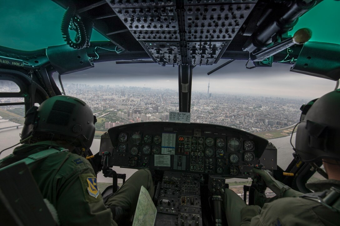 Col. Robert Dotson, 374th Operations Group commander, and Capt. Brandon Jones, 374th Airlift Wing UH-1N pilot, fly over Tokyo during Col. Dotson’s fini flight, May 25, 2017. Known as “fini flight,” military aviators have a tradition where after completion of their final flight, aircrew members are met and hosed down with water by their group comrades, family and friends. (U.S. Air Force photo by Yasuo Osakabe)