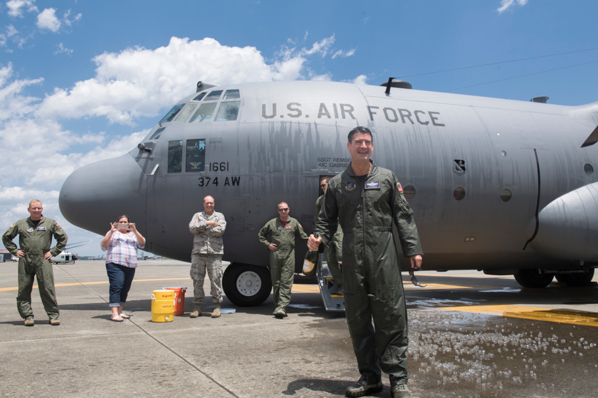 Col. Robert L. Dotson, 374th Operations commander, is doused in water to celebrate the end of his final flight, June 2, 2017, at Yokota Air Base, Japan. Fini flights follow an Air Force tradition where aircrew members are met and hosed down with water by their group comrades, families and friends. (U.S. Air Force photo by Airman 1st Class Juan Torres)