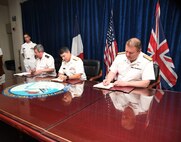 MANAMA, Bahrain (June 1, 2017) Vice Adm. Louis-Michel Guillaume, left, commander of French Submarine and Strategic Oceanic Forces, Vice Adm. Kevin M. Donegan, middle, commander of the U.S. Naval Forces Central Command, and Rear Adm. Robert K. Tarrant, commander Operations of the Royal Navy, sign an agreement to increase coordination for anti-submarine warfare activities between France, the U.S. and the United Kingdom. The agreement follows the signing of a trilateral cooperation agreement by Chief of Naval Operations Adm. John Richardson, the First Sea Lord of the United Kingdom Adm. Sir Philip Jones and French Chief of Naval Staff Adm. Christophe Prazuck in London on March 27. (U.S. Navy photo by Mass Communications Specialist 2nd Class Victoria Kinney/Released) 