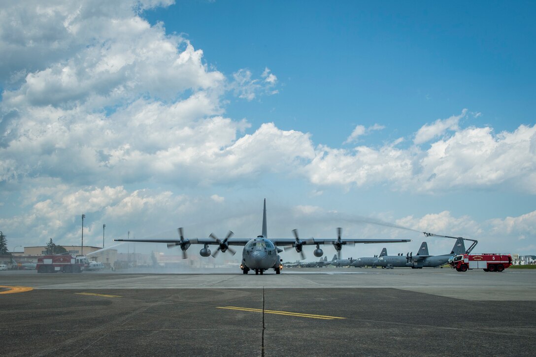 A C-130H Hercules taxies through water salute June, 2, 2017, Yokota Air Base, Japan. The flight marked Col. Robert Dotson’s, 374th Operations Group commander, fini flight at Yokota Air Base. (U.S. Air Force photo by Airman 1st Class Donald Hudson)