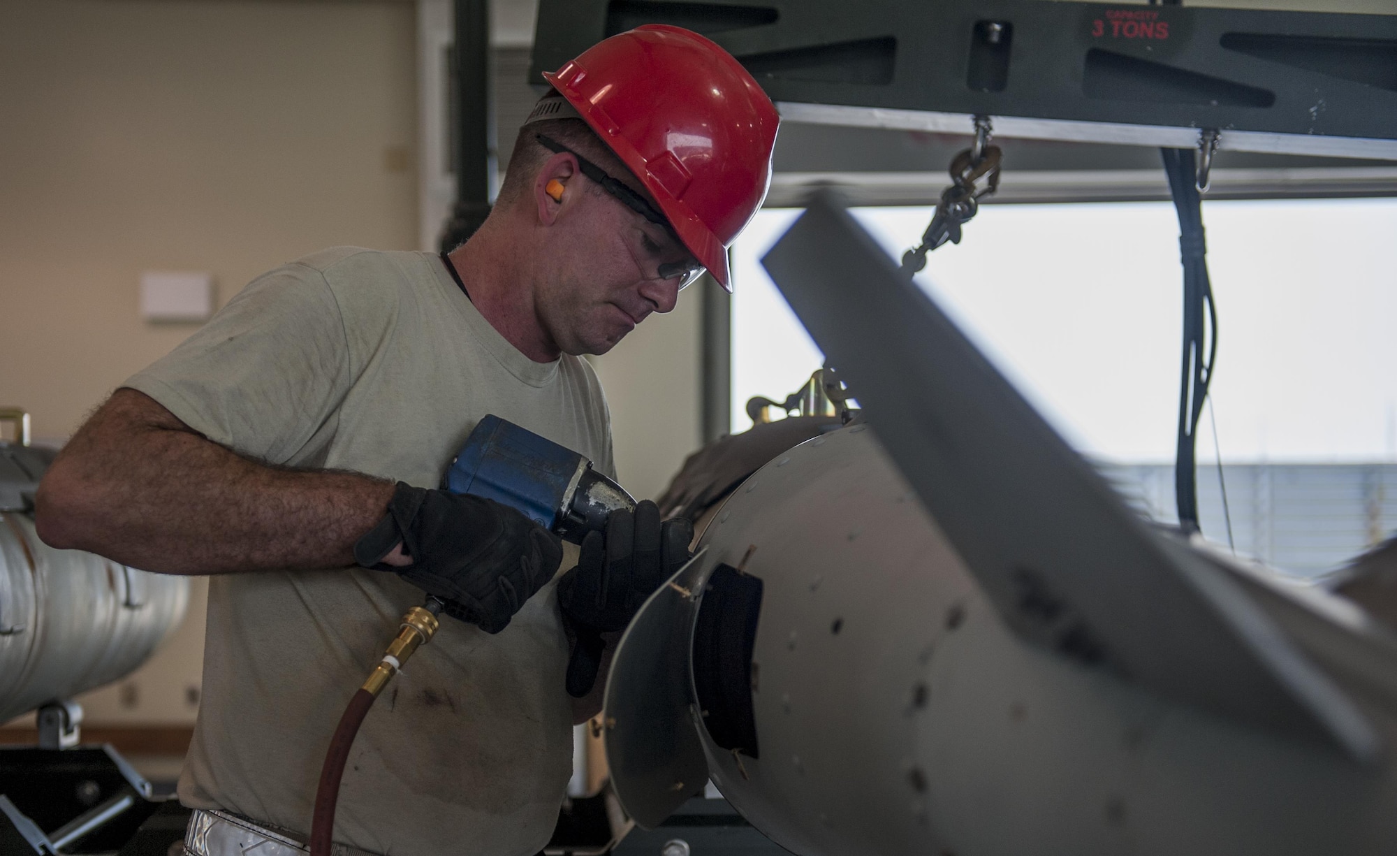 U.S. Air Force Staff Sgt. Shawn Monteer, 8th Maintenance Squadron conventional maintenance crew member, tightens the bolts on the tail wing of a Guided Bomb Unit 31 version 3 during the Combat Ammunition Production Exercise at Kunsan Air Base, Republic of Korea, June 5, 2017. Airmen involved in CAPEX were evaluated on their ability to generate munitions in a total force environment. (U.S. Air Force photo by Senior Airman Colville McFee/Released) 
